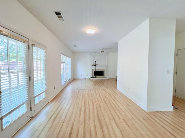 unfurnished living room with light hardwood / wood-style floors and ceiling fan