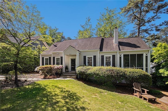 ranch-style house with a chimney and a front yard