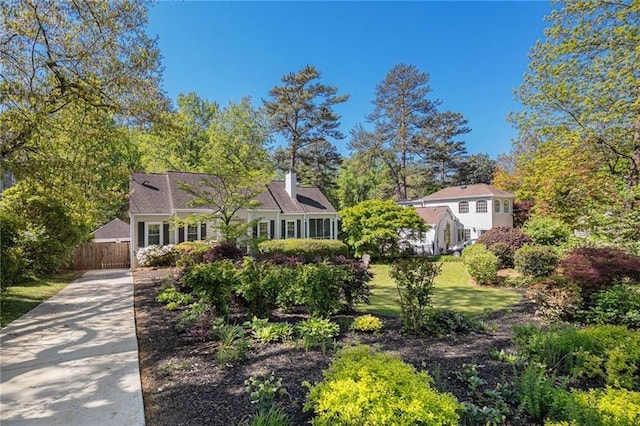 view of front of property featuring concrete driveway, a front yard, and fence