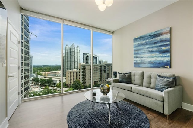 1080 Peachtree St NE Unit 1402, Atlanta, GA 30309 - living area with wood finished floors, plenty of natural light, a view of city, and baseboards