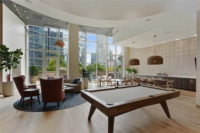 1080 Peachtree St NE Unit 1402, Atlanta, GA 30309 - rec room with a high ceiling, light wood-style flooring, wallpapered walls, billiards, and a wall of windows