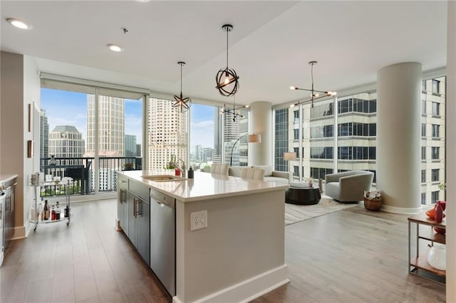 1080 Peachtree St NE Unit 1402, Atlanta, GA 30309 - kitchen featuring dark wood-style flooring, light countertops, stainless steel dishwasher, and recessed lighting