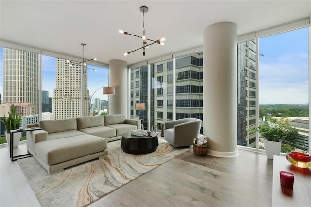1080 Peachtree St NE Unit 1402, Atlanta, GA 30309 - living area with floor to ceiling windows, a chandelier, wood finished floors, and a city view