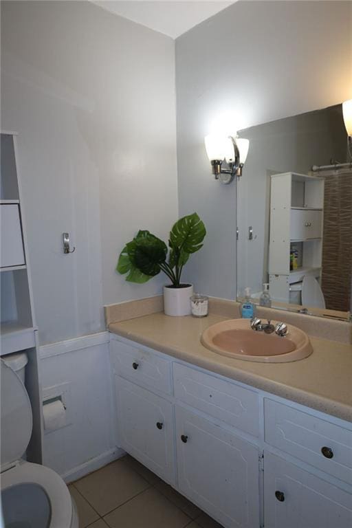 bathroom with vanity, tile patterned floors, and toilet