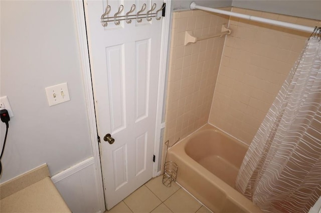 bathroom featuring tile patterned floors and shower / bath combo with shower curtain