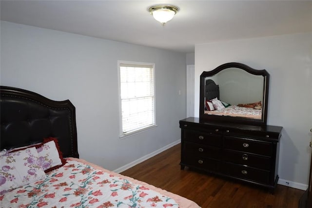 bedroom with baseboards and dark wood-style floors