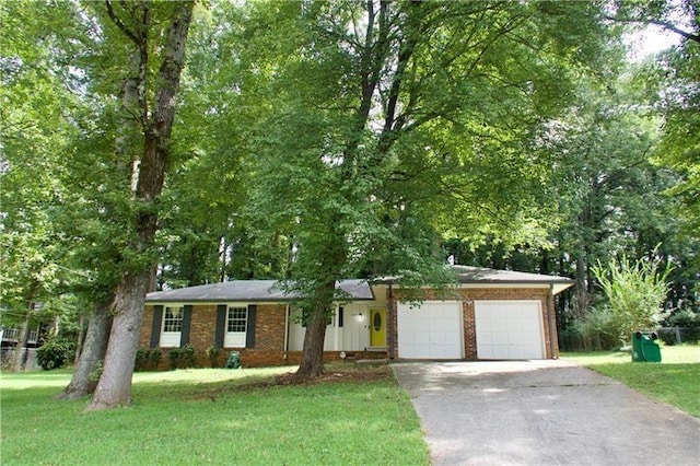 single story home with a front lawn, an attached garage, brick siding, and driveway