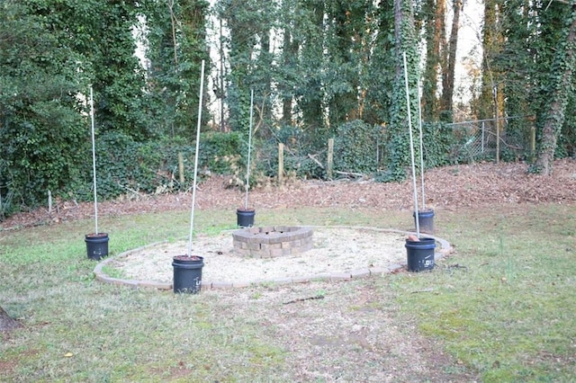 view of yard featuring a fire pit and fence