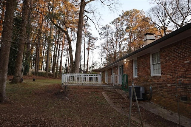 view of yard with a wooden deck and central AC