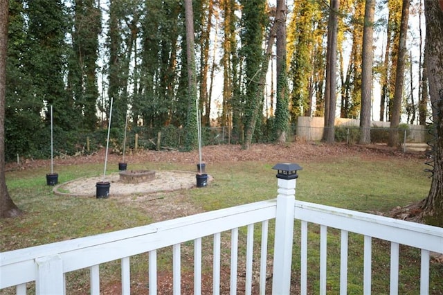 view of yard with a fire pit and fence