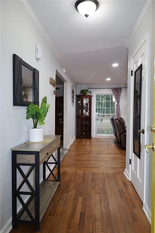 hall with recessed lighting, baseboards, wood finished floors, and ornamental molding