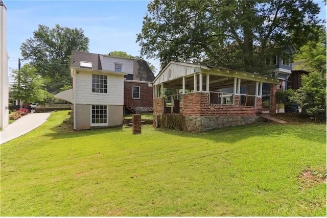 rear view of property with a yard