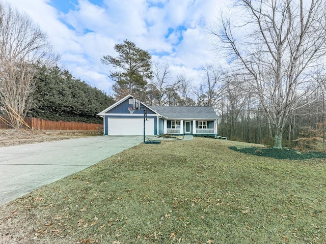 view of front of property featuring a garage, a front yard, and covered porch