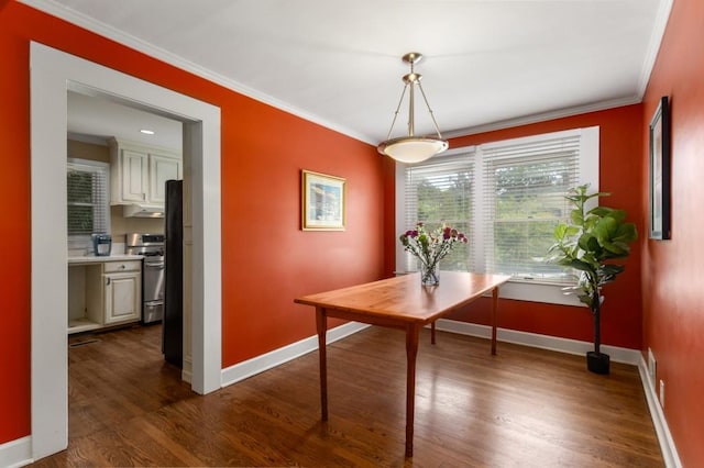 6596 Wright Rd NE, Atlanta, GA 30328 - dining space featuring baseboards, crown molding, and dark wood finished floors