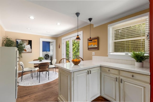 6596 Wright Rd NE, Atlanta, GA 30328 - kitchen featuring washer / dryer, crown molding, french doors, freestanding refrigerator, and a peninsula