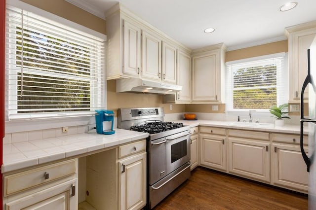 6596 Wright Rd NE, Atlanta, GA 30328 - kitchen featuring double oven range, under cabinet range hood, a sink, ornamental molding, and tile countertops