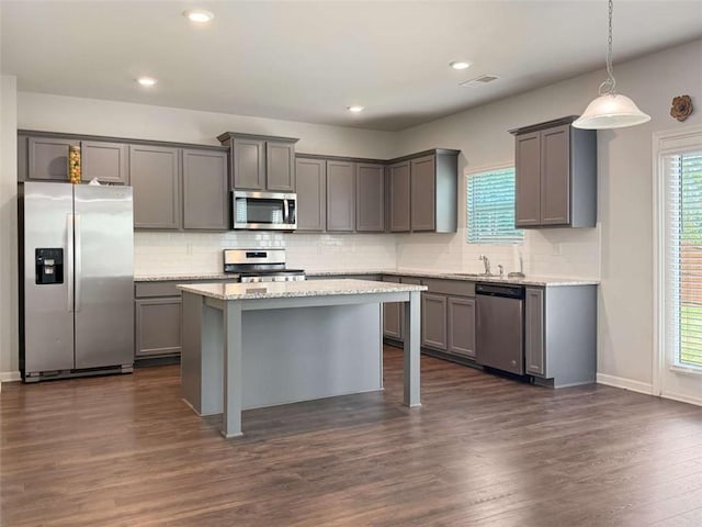 3062 Hawthorn Farm Blvd, Loganville, GA 30052 - kitchen with appliances with stainless steel finishes, gray cabinetry, tasteful backsplash, and recessed lighting