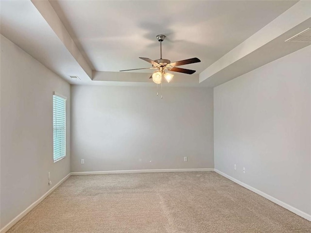 3062 Hawthorn Farm Blvd, Loganville, GA 30052 - unfurnished room featuring a tray ceiling, a ceiling fan, light colored carpet, and baseboards