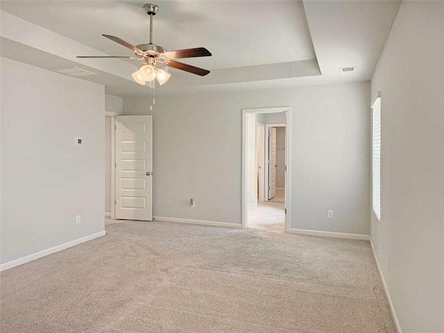 3062 Hawthorn Farm Blvd, Loganville, GA 30052 - empty room featuring ceiling fan, light colored carpet, baseboards, and a raised ceiling