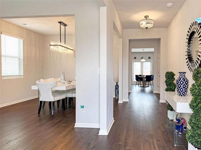 3062 Hawthorn Farm Blvd, Loganville, GA 30052 - dining space with a chandelier, dark wood-type flooring, and baseboards
