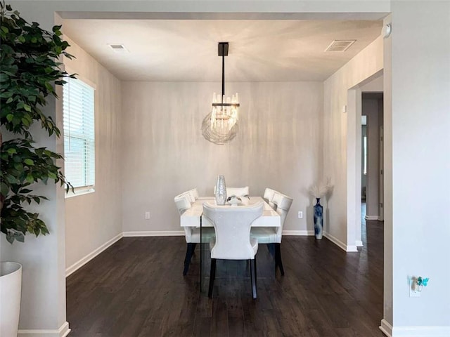 3062 Hawthorn Farm Blvd, Loganville, GA 30052 - dining space featuring dark wood-style flooring, a chandelier, and baseboards
