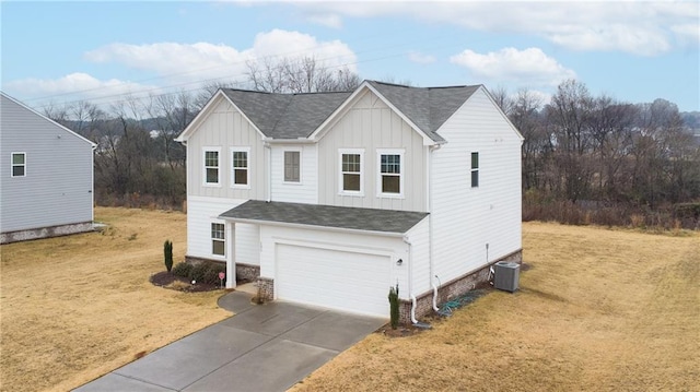 view of front facade with central air condition unit, a front lawn, board and batten siding, concrete driveway, and a garage