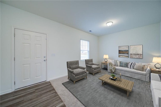 living area featuring dark wood-type flooring and baseboards