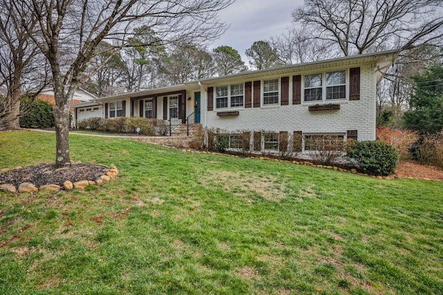 view of front of house featuring a garage and a front lawn