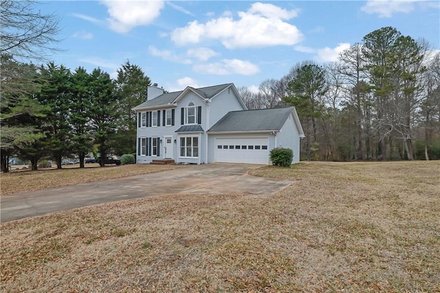 view of front of home with a garage and a front yard