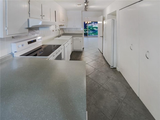 kitchen featuring white cabinetry, white appliances, dark tile patterned floors, sink, and decorative backsplash