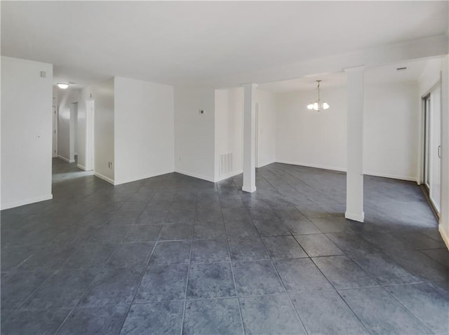 interior space featuring dark tile patterned floors and a notable chandelier