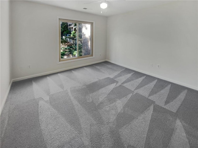 unfurnished room featuring ceiling fan and light carpet