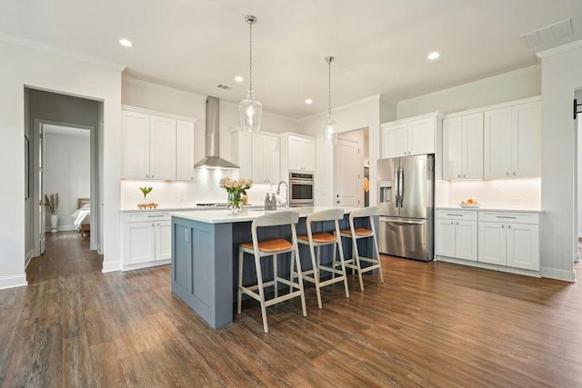kitchen with white cabinets, appliances with stainless steel finishes, decorative backsplash, and wall chimney exhaust hood