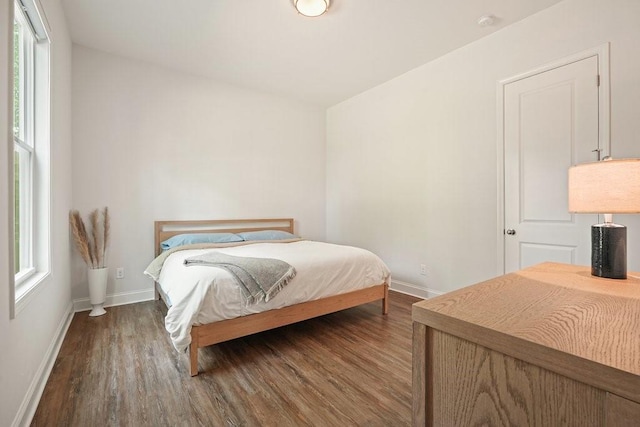 bedroom featuring baseboards and wood finished floors