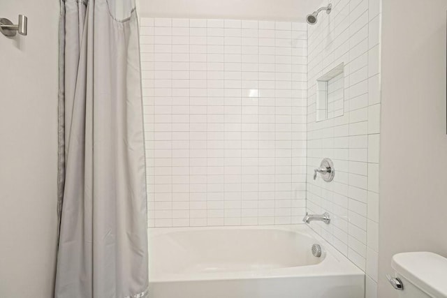 full bath with toilet and shower / bath combo