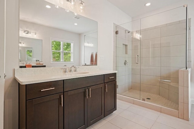 bathroom with vanity, tile patterned flooring, a stall shower, and recessed lighting
