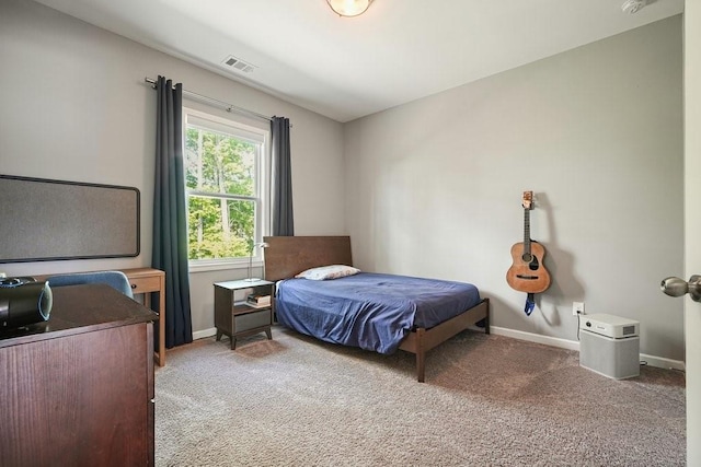 carpeted bedroom with baseboards and visible vents