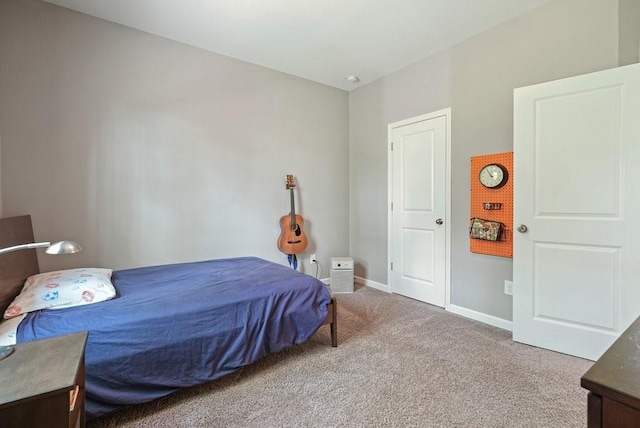 bedroom with baseboards and carpet flooring