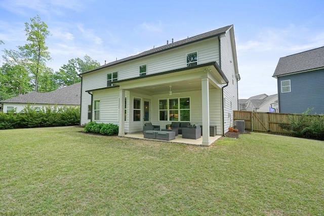 rear view of house with fence, a yard, a patio, and an outdoor living space