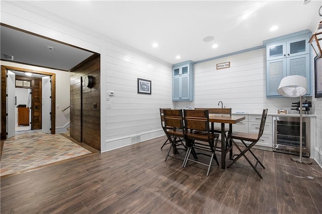61 Alden Ave NW, Atlanta, GA 30309 - dining area featuring dark wood finished floors, wooden walls, recessed lighting, and beverage cooler