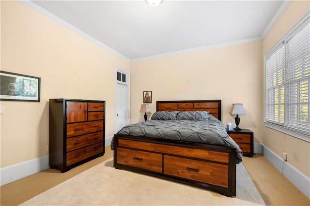 bedroom with baseboards, crown molding, and light colored carpet