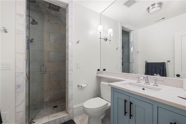 bathroom featuring visible vents, a shower stall, toilet, and vanity