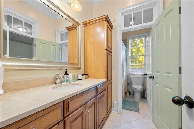 bathroom featuring vanity, tile patterned floors, and toilet