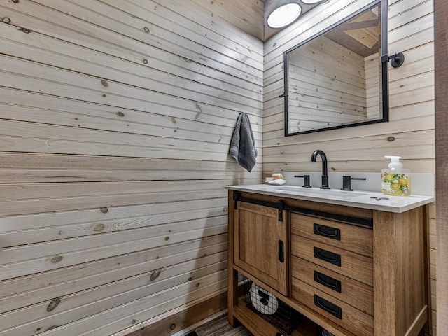 bathroom with vanity and wood walls