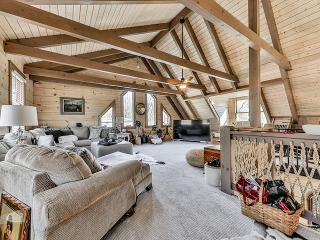 living room with carpet floors, vaulted ceiling with beams, ceiling fan, and wood walls