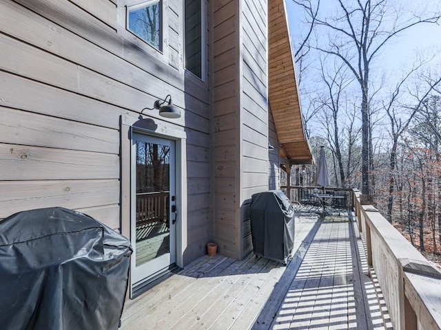 wooden terrace featuring a grill