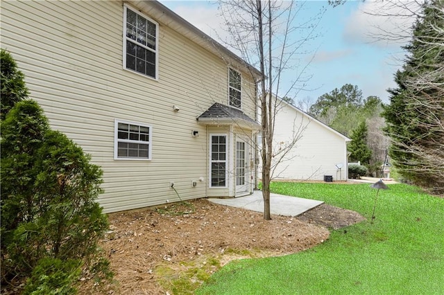 rear view of house featuring a patio area and a yard