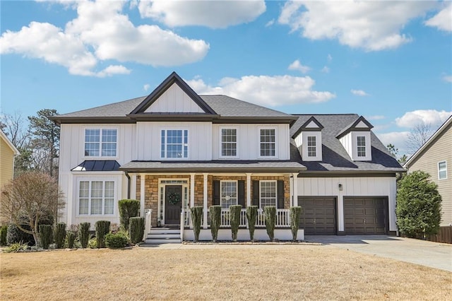 view of front of home featuring a garage, board and batten siding, covered porch, and driveway