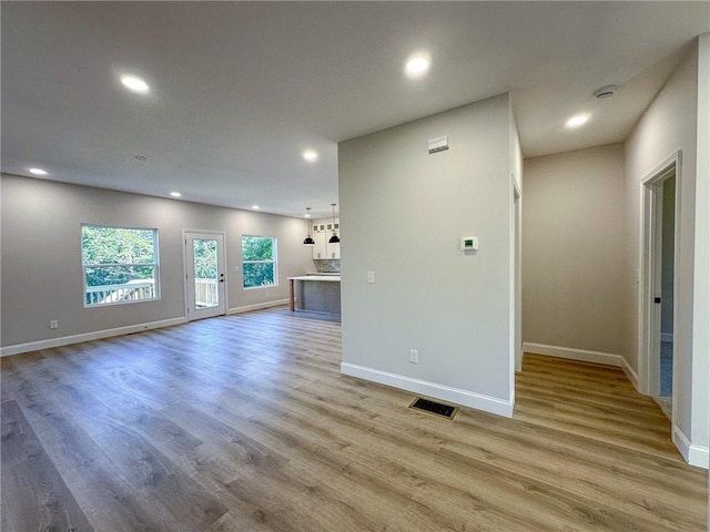 unfurnished living room featuring light wood-type flooring