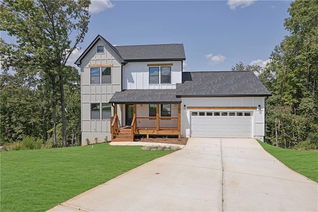 view of front of property with covered porch, a garage, and a front yard